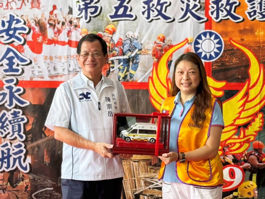 《圖說》消防局長陳崇岳回贈救護車模型給予顧蓓靜。〈消防局提供〉